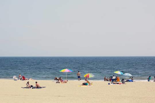 beachgoers enjoying rockaway beach 
